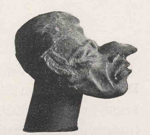 Photograph of a sculpture of a head with an elongated face.